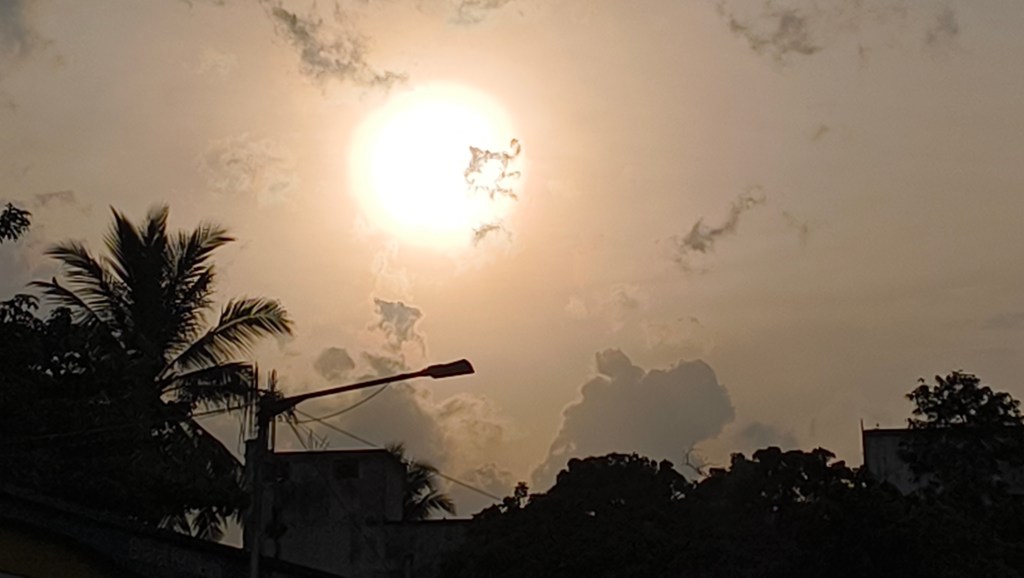 Photo of with traces of cloud and a streetlamp in the foreground