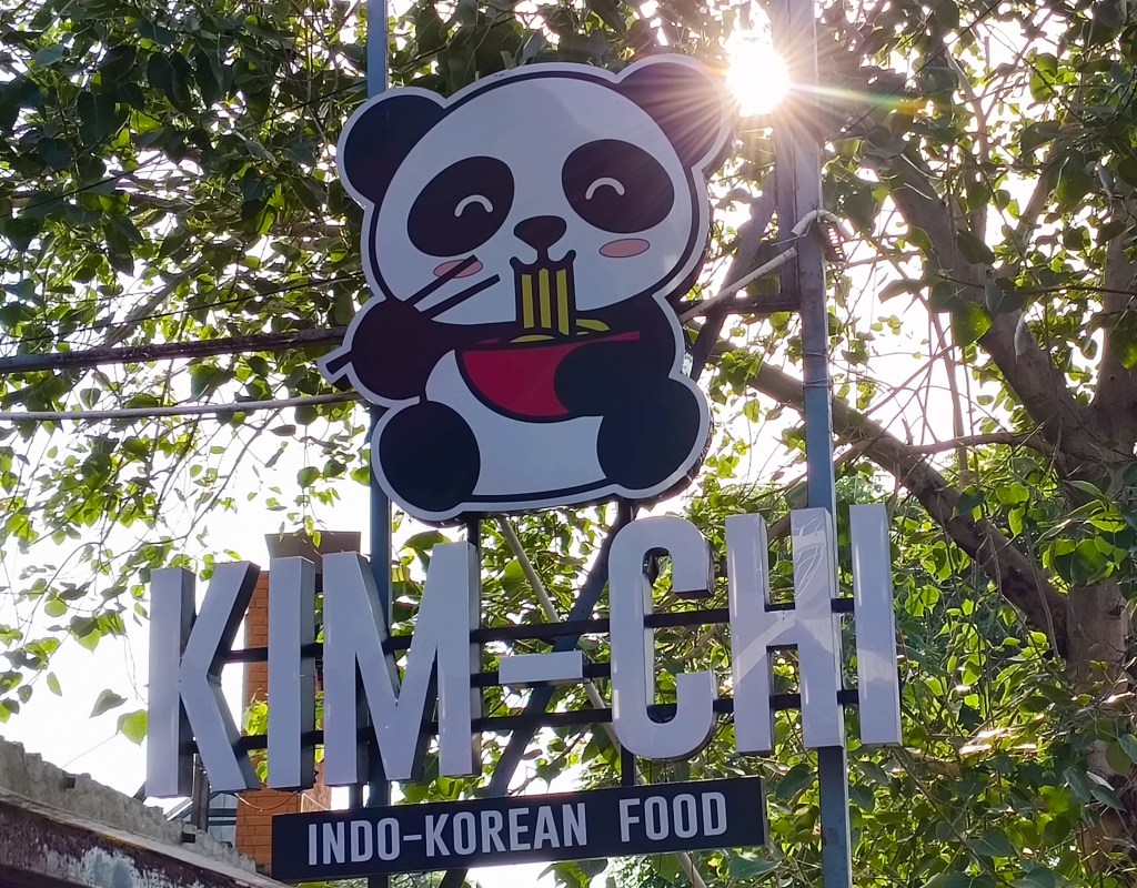 Hoarding showing cartoon panda eating noodles